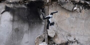Banksy plasma uno de sus grafitis sobre un edificio en ruinas de Ucrania