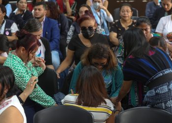 Algunos familiares de víctimas oran durante la audiencia de sentencia.