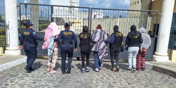 Agentes de la DEIC conducen a algunas de las personas capturadas por narcomenudeo en Quetzaltenango.
