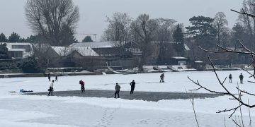 Algunas personas patinan sobre el hielo en un brazo del río Danubio, que se congeló a causa del frío extremo.