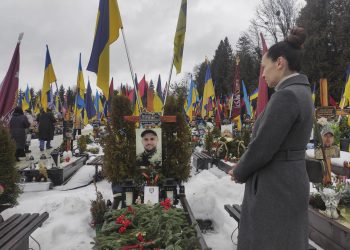 Irina Farion, de 40 años, viuda del soldado voluntario ucraniano Oleksandr Alimov, visita su tumba en el cuarto aniversario de la invasión rusa en Ucrania.