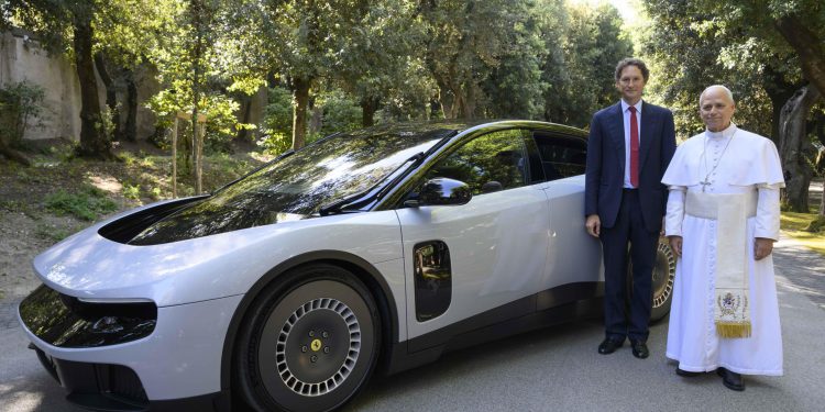 El papa León XIV y el presidente de Ferrari, junto al primer automóvil eléctrico de esa casa automotriz.