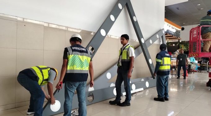 Trabajadores retiran las estructuras de iluminación que llegaron al final de su vida útil en el área de salida de pasajeros de La Aurora. / Foto: DGAC.